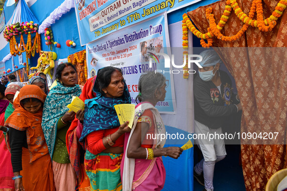 Devotees are queuing outside a free eye checkup camp at the Gangasagar transit camp in Kolkata, India, on January 11, 2024. 