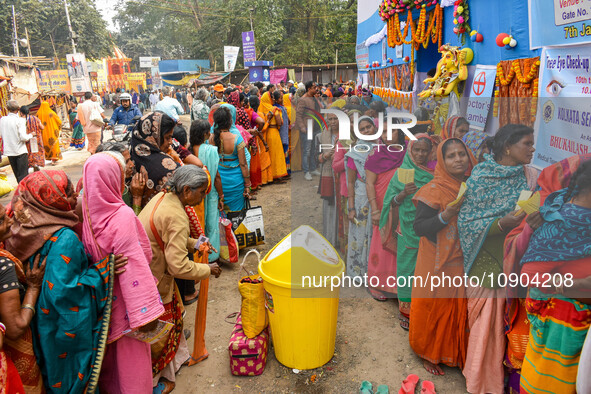 Devotees are queuing outside a free eye checkup camp at the Gangasagar transit camp in Kolkata, India, on January 11, 2024. 