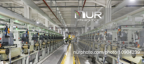 A worker is producing steel cord at a workshop in Huai'an, China, on January 11, 2024. 