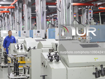 A worker is producing steel cord at a workshop in Huai'an, China, on January 11, 2024. (