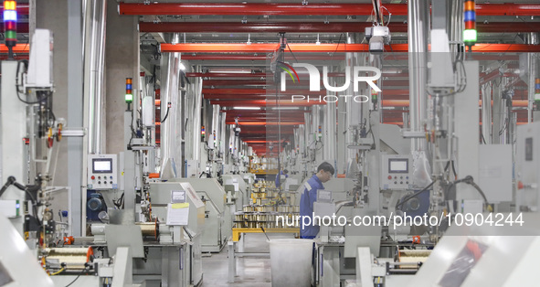 A worker is producing steel cord at a workshop in Huai'an, China, on January 11, 2024. 