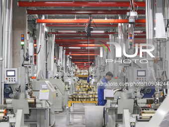 A worker is producing steel cord at a workshop in Huai'an, China, on January 11, 2024. (