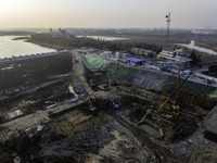 Workers are working at the construction site of the Yundong Gate rescue and reinforcement project east of the intersection of the Subei Irri...