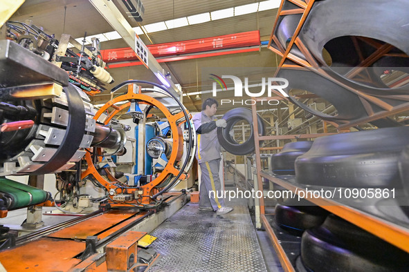 A worker is working on the production line of a tire manufacturing company in the Qingzhou Economic Development Zone, in Qingzhou, China, on...