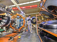 A worker is working on the production line of a tire manufacturing company in the Qingzhou Economic Development Zone, in Qingzhou, China, on...