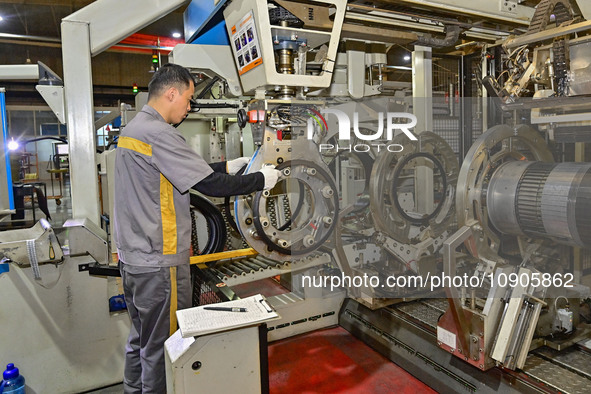 A worker is working on the production line of a tire manufacturing company in the Qingzhou Economic Development Zone, in Qingzhou, China, on...