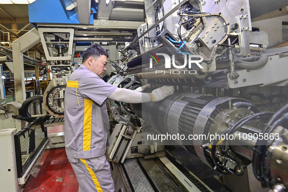 A worker is working on the production line of a tire manufacturing company in the Qingzhou Economic Development Zone, in Qingzhou, China, on...