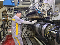 A worker is working on the production line of a tire manufacturing company in the Qingzhou Economic Development Zone, in Qingzhou, China, on...