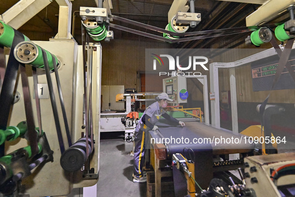 A worker is working on the production line of a tire manufacturing company in the Qingzhou Economic Development Zone, in Qingzhou, China, on...