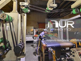 A worker is working on the production line of a tire manufacturing company in the Qingzhou Economic Development Zone, in Qingzhou, China, on...