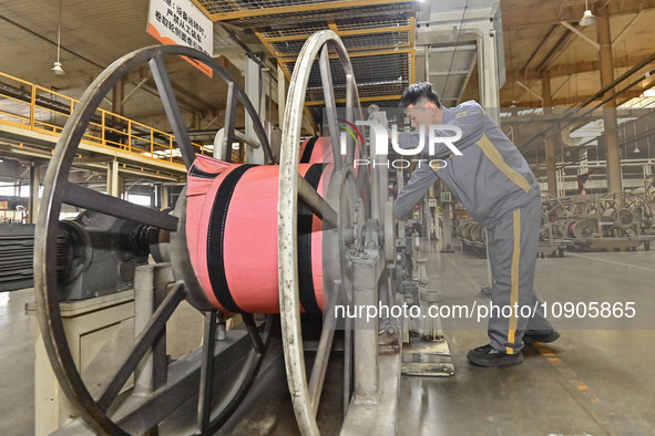 A worker is working on the production line of a tire manufacturing company in the Qingzhou Economic Development Zone, in Qingzhou, China, on...