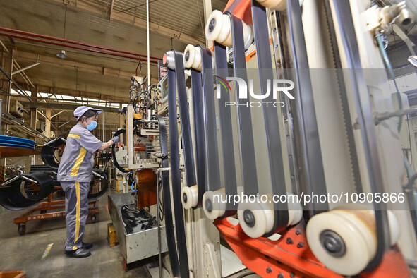 A worker is working on the production line of a tire manufacturing company in the Qingzhou Economic Development Zone, in Qingzhou, China, on...