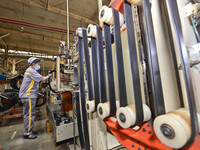 A worker is working on the production line of a tire manufacturing company in the Qingzhou Economic Development Zone, in Qingzhou, China, on...