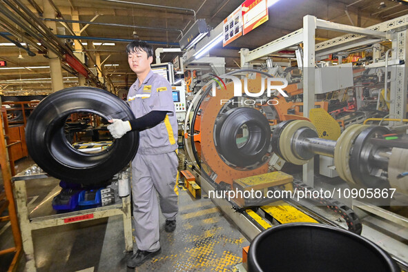 A worker is working on the production line of a tire manufacturing company in the Qingzhou Economic Development Zone, in Qingzhou, China, on...