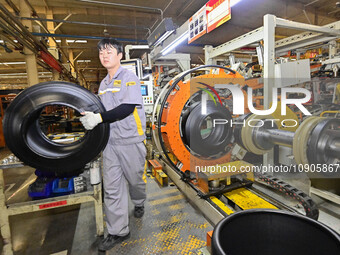 A worker is working on the production line of a tire manufacturing company in the Qingzhou Economic Development Zone, in Qingzhou, China, on...