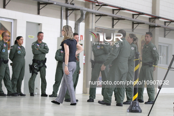 Military police are moving in the hangar of the air group in Sao Paulo, Brazil, on January 12, 2024, after finding the helicopter that went...