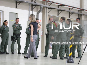 Military police are moving in the hangar of the air group in Sao Paulo, Brazil, on January 12, 2024, after finding the helicopter that went...