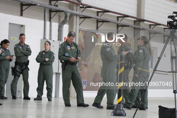 Military police are moving in the hangar of the air group in Sao Paulo, Brazil, on January 12, 2024, after finding the helicopter that went...