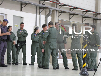 Military police are moving in the hangar of the air group in Sao Paulo, Brazil, on January 12, 2024, after finding the helicopter that went...