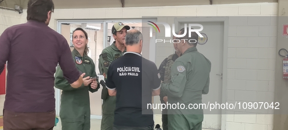 Military police are moving in the hangar of the air group in Sao Paulo, Brazil, on January 12, 2024, after finding the helicopter that went...