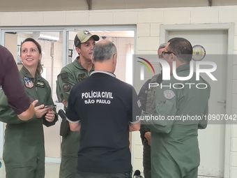 Military police are moving in the hangar of the air group in Sao Paulo, Brazil, on January 12, 2024, after finding the helicopter that went...