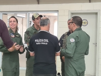 Military police are moving in the hangar of the air group in Sao Paulo, Brazil, on January 12, 2024, after finding the helicopter that went...