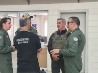 Military police are moving in the hangar of the air group in Sao Paulo, Brazil, on January 12, 2024, after finding the helicopter that went...