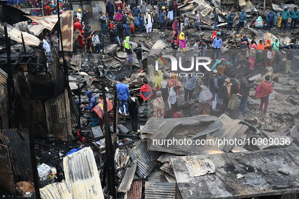 Slum-dwellers in Bangladesh were seen searching for their household belongings after a devastating fire broke out at the Karwan Bazar slum i...