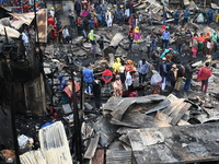 Slum-dwellers in Bangladesh were seen searching for their household belongings after a devastating fire broke out at the Karwan Bazar slum i...