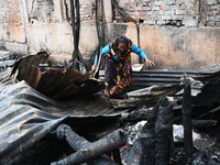 Slum-dwellers in Bangladesh were seen searching for their household belongings after a devastating fire broke out at the Karwan Bazar slum i...