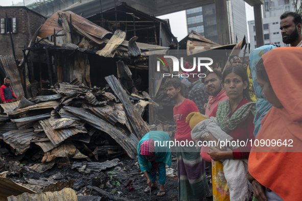 Slum-dwellers are searching for their household belongings following a devastating fire that broke out at the Karwan Bazar slum in Dhaka, Ba...