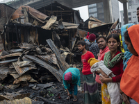 Slum-dwellers are searching for their household belongings following a devastating fire that broke out at the Karwan Bazar slum in Dhaka, Ba...