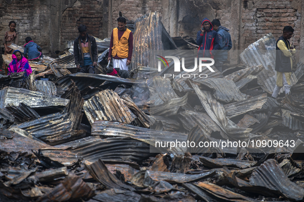 Slum-dwellers are searching for their household belongings following a devastating fire that broke out at the Karwan Bazar slum in Dhaka, Ba...