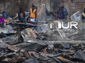 Slum-dwellers are searching for their household belongings following a devastating fire that broke out at the Karwan Bazar slum in Dhaka, Ba...