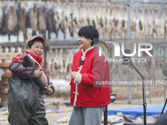 A worker is promoting cured fish through an online live broadcast in Huai'an, China, on January 14, 2024. (