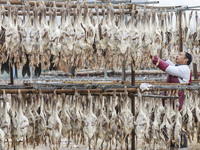 A worker is drying ducks in Huai'an, China, on January 14, 2024. (