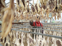 A worker is drying ducks in Huai'an, China, on January 14, 2024. (