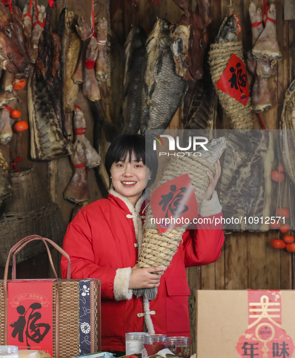 A worker is sticking a ''Fu'' sticker on a package of cured fish in Huai'an, China, on January 14, 2024. 