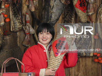 A worker is sticking a ''Fu'' sticker on a package of cured fish in Huai'an, China, on January 14, 2024. (