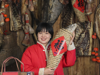 A worker is sticking a ''Fu'' sticker on a package of cured fish in Huai'an, China, on January 14, 2024. (