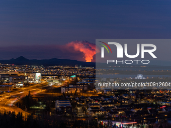 A volcano is spewing lava and smoke as it erupts in Reykjanes Peninsula, Iceland, on January 14, 2024. The volcanic eruption, which occurred...