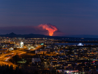 A volcano is spewing lava and smoke as it erupts in Reykjanes Peninsula, Iceland, on January 14, 2024. The volcanic eruption, which occurred...