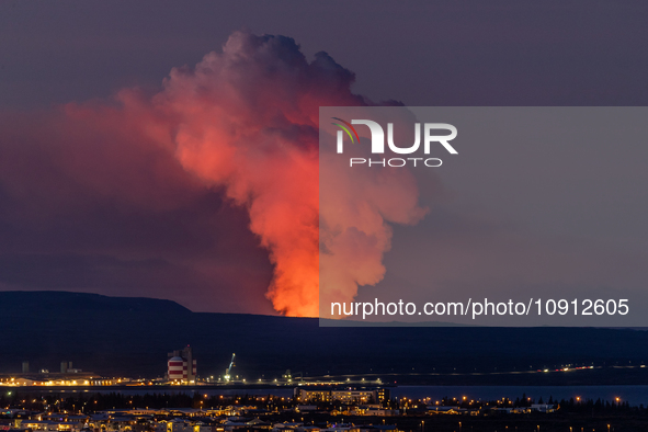 A volcano is spewing lava and smoke as it erupts in Reykjanes Peninsula, Iceland, on January 14, 2024. The volcanic eruption, which occurred...