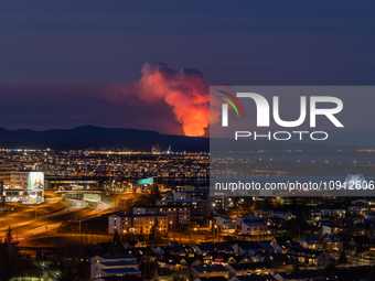 A volcano is spewing lava and smoke as it erupts in Reykjanes Peninsula, Iceland, on January 14, 2024. The volcanic eruption, which occurred...