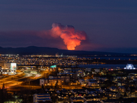 A volcano is spewing lava and smoke as it erupts in Reykjanes Peninsula, Iceland, on January 14, 2024. The volcanic eruption, which occurred...