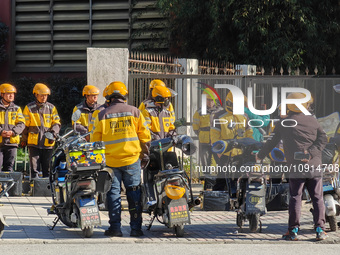 Many Meituan food delivery workers are lining up to make preparations in Shanghai, China, on January 14, 2024. (