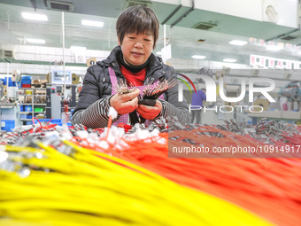 A worker is producing PTC heating block products at a micro factory in Xiashe village, Huzhou, China, on January 15, 2024. (