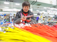 A worker is producing PTC heating block products at a micro factory in Xiashe village, Huzhou, China, on January 15, 2024. (