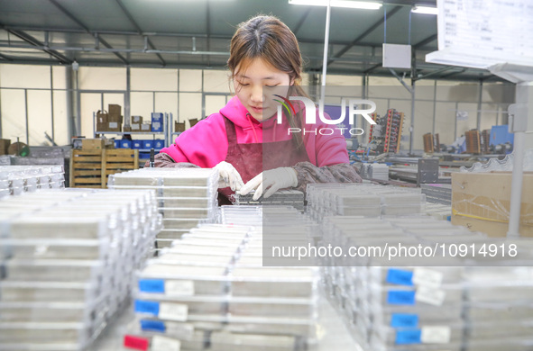 A worker is producing PTC heating block products at a micro factory in Xiashe village, Huzhou, China, on January 15, 2024. 