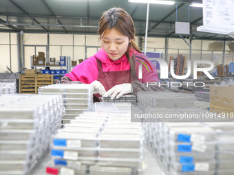 A worker is producing PTC heating block products at a micro factory in Xiashe village, Huzhou, China, on January 15, 2024. (